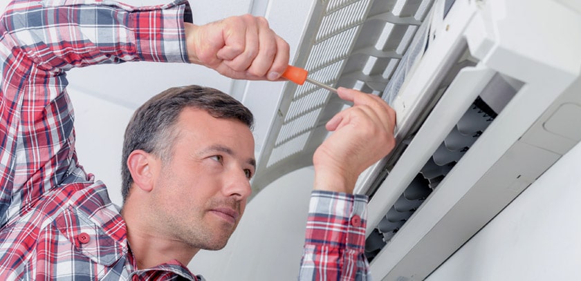 a man repairing an AC in boca raton